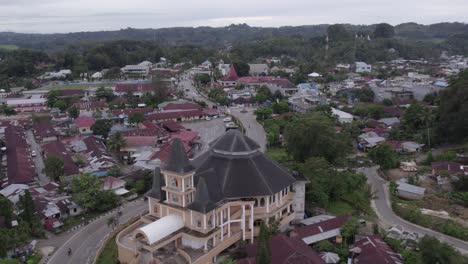 Reveal-shot-of-catholic-church-at-Waikaboebak-Sumba-island,-aerial
