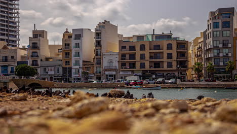 Timelapse-of-buildings-by-the-sea-in-Valletta,-Malta