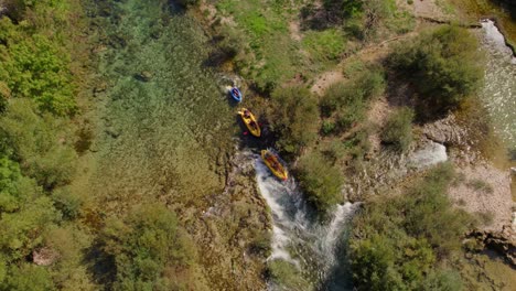Top-down-shot-of-Group-of-tourists-in-kayaking-view-from-a-height-Zrmanja-river,-aerial