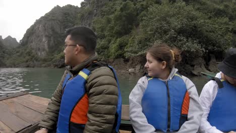 boat-journey-through-the-waters-of-Halong-Bay-in-Vietnam,-as-tourists-glide-through-this-UNESCO-World-Heritage-Site