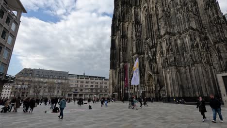 People-Walking-Across-Public-Square-In-Front-Of-Cologne-Cathedral