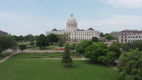 Low-aerial-shot-rising-over-the-treetops-towards-the-Minnesota-State-Capitol-building-in-Saint-Paul,-Minnesota