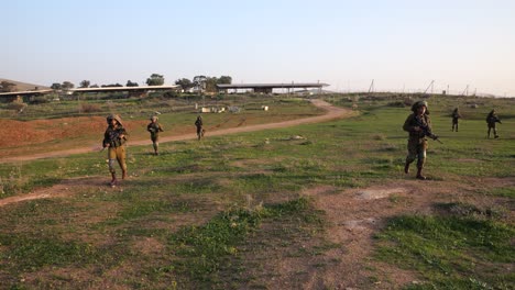 Soldiers-finding-a-practice-grenade-in-the-battle-field,-wide-view