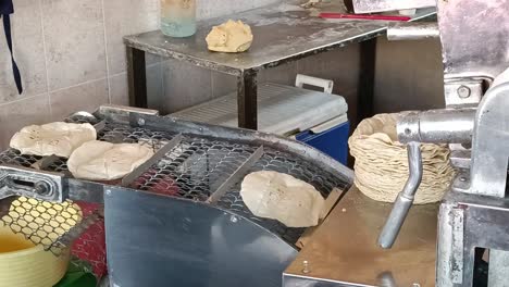 People-are-making-bread-in-an-automated-machine-in-a-kitchen-of-a-restaurant