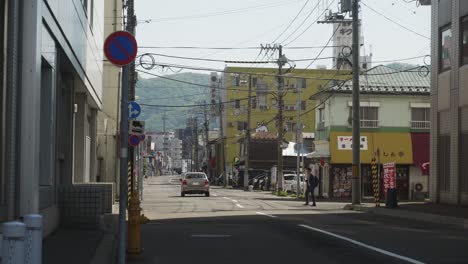 Car-Driving-Down-Downtown-Street-In-Hakodate,-Hokkaido-In-The-Morning