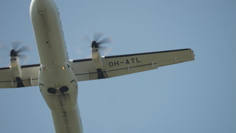 Looking-straight-up-at-a-propellor-airplane-flying-by