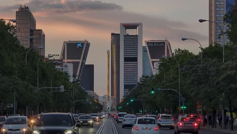 Madrid-main-street-paseo-de-la-castellana-during-colorful-sunset-and-city-traffic-skyscrappers-view
