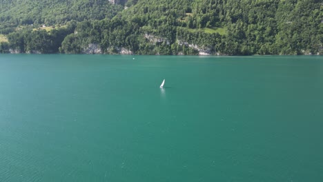 Yacht-having-leisure-time-sailing-solo-in-calm-lake-waters,Switzerland
