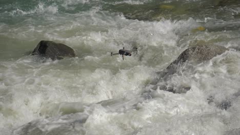 Drone-Mavic-2-Pro-flying-above-powerful-river-stream-falls,-slow-motion,-day