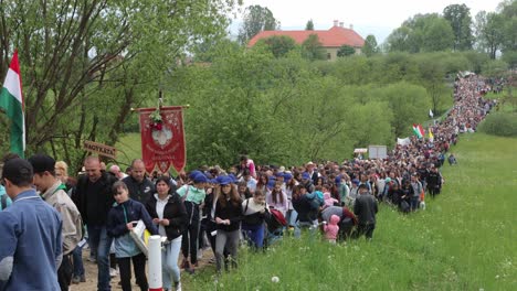 Huge-crowd-of-people-on-Csiksomlyo-pilgrimage-walking-up-narrow-mountain-path