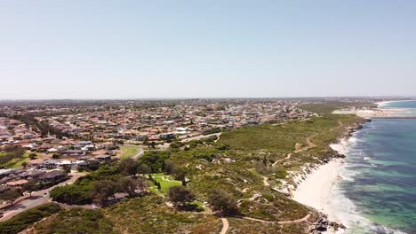 Above-the-grass,-sandy-beach-and-residential-area-at-Ocean-Reef,-Perth