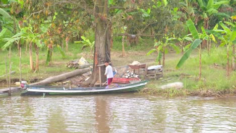 Rare-sight-of-Amazon-indigenous-family-living-in-a-wooden-house-in-the-middle-of-the-Amazon-jungle-river,-Brazil