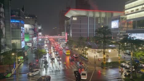 Aerial-establishing-shot-showing-traffic-on-main-road-in-Taipei-City-during-rainy-day-at-night