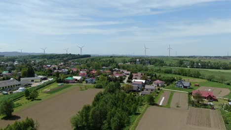 Calm-peaceful-polish-neighborhood-with-wind-farm-turbines-in-distance