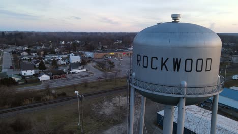 South-Rockwood-water-tower-with-small-township-behind,-aerial-orbit-view