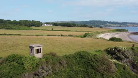 Traeth-Lligwy-Anglesey-eroded-coastal-shoreline-aerial-view-green-cliff-birdwatching-hide