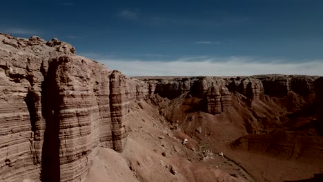 Flying-next-to-red-sandstone-cliffs-in-a-desert-wilderness