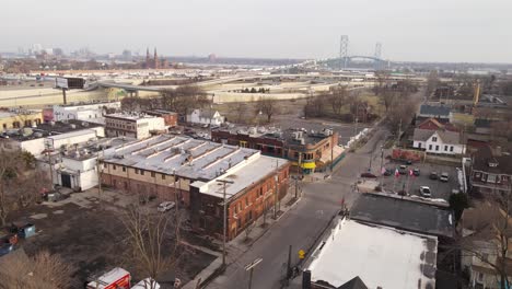 Small-cozy-township-with-Ambassador-bridge-in-horizon,-aerial-drone-view