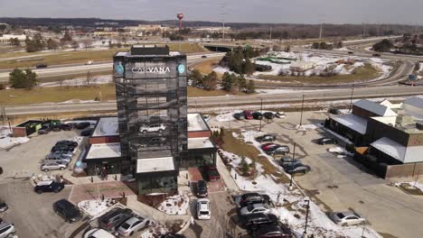 Carvana-car-sales-building-in-Michigan,-aerial-drone-orbit-view