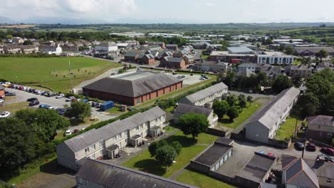 Welsh-Llangefni-village-aerial-view-looking-down-over-sunny-small-town-low-income-suburban-homes