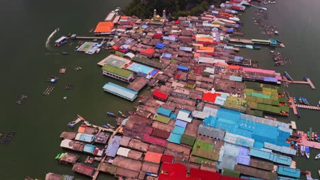 Panyee-floating-village-aerial-view-in-which-the-whole-village-floating-in-the-water-is-visible-colorful-in-which-the-sports-ground-solar-panels-are-visible-colorful-colorful-houses
