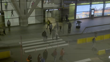 Passengers-Coming-Out-Of-The-Airport-At-The-Arriving-Area-In-Gdańsk,-Poland