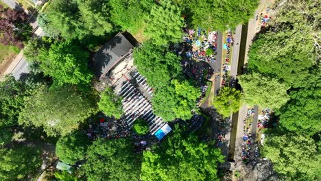 Aerial-rotating-view-of-a-community-gathering-in-a-local-park-on-a-beautiful-summer-day