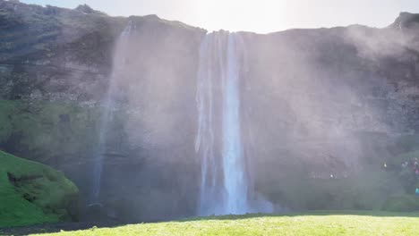 Iceland---Discover-the-allure-of-Seljalandsfoss,-where-the-harmony-of-nature-and-the-elements-create-a-breathtaking-sight