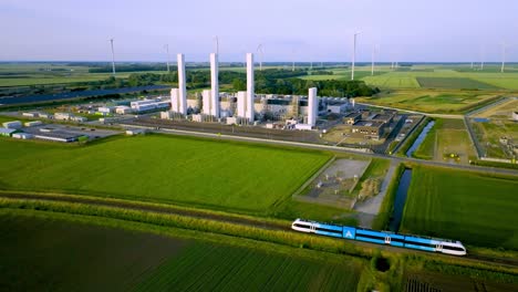 Arriva-Train-Driving-Past-Nitrogen-Factory-Zuidbroek,-Making-Consumer-Gas-for-Netherlands