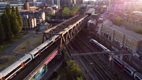 Drone-shot-overground-train-travelling-through-Shoreditch-in-London