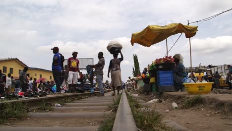 Lagos-Market.-Woman-walks-along-railwa