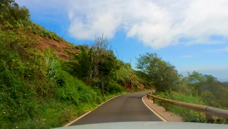 Cinematic-Drive-On-A-Curvy-Empty-Mountain-Road,-Surrounded-By-Tall-Green-Mountains,-Clear-Blue-Sky,-Atlantic-Ocea,-Canary-Islands,-La-Gomera,-Spain,-Europe