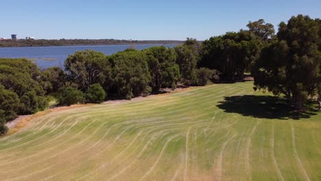 Aerial-footage-over-Rotary-Park,-Wanneroo-WA-and-views-across-the-lake