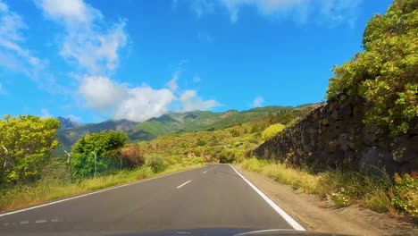 Breathtaking-Drive-Up-The-Winding-Mountain-Road,-Driver-POV,-Surrounded-By-Majestic-Mountains-And-Verdant-Vegetation,-Teide-National-Park,-Tenerife,-Canary-Islands,-Spain