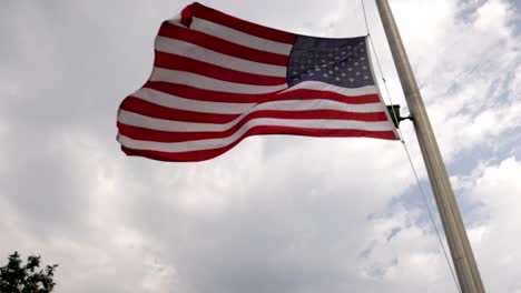 American-flag-flying-in-the-wind-in-Houston,-Texas-with-a-pan-to-Texas-state-flag