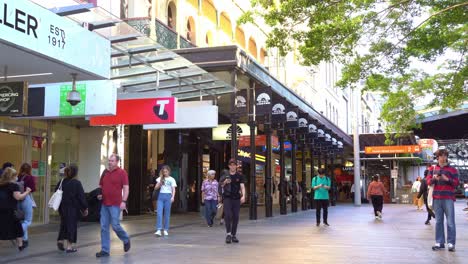 Static-shot-capturing-bustling-downtown-Brisbane-city-at-Queen-street-mall-with-people-strolling-at-the-outdoor-pedestrian-shopping-mall,-Myer-closing-down-sale-at-namesake-shopping-centre