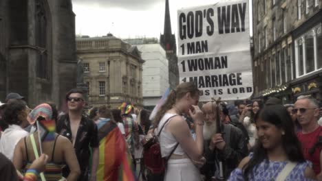 A-person-supporting-the-pride-march-confronts-an-elderly-man-with-a-slogan-that-reads-"1-man,-1-woman,-1-marriage,"-highlighting-the-ongoing-debates-around-equality-and-LGBTQ-rights