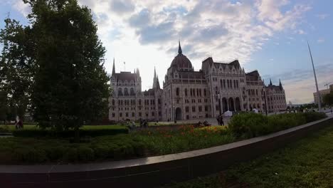 Hungarian-Parliament-Building-at-Kossuth-Lajos-Square,-with-the-equestrian-statue-of-Francis-II-Rákóczi,-filmed-from-a-tram-with-wide-angle-lens-on-a-sunny-summer-afternoon---Budapest,-June-2023