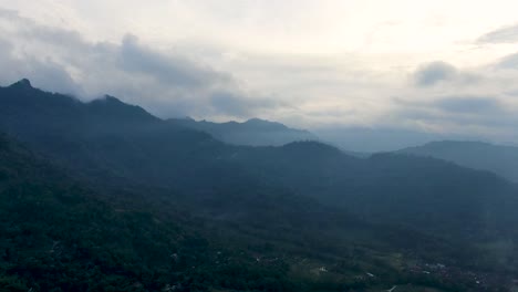 Silhouette-of-Menoreh-mountains-on-foggy-afternoon,-aerial-drone-view
