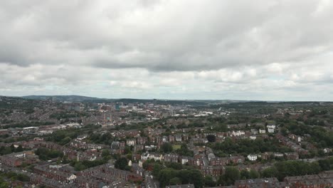 Aerial-drone-footage-pulling-away-over-British-city-suburbs,-Sheffield