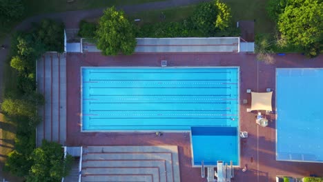 Amazing-aerial-top-view-flight-Berlin-city-Public-swimming-pool-Germany-in-Europe,-summer-day-2023