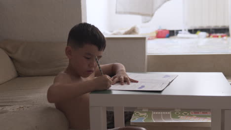 Little-boy-practice-how-to-write-during-summer-holiday