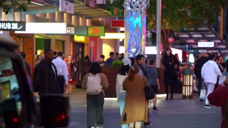 Swarm-of-people-shopping-and-dinning-at-bustling-Queen-street-mall-at-night,-static-shot-capturing-large-crowds-in-downtown-Brisbane-city-Albert-street-in-the-evening