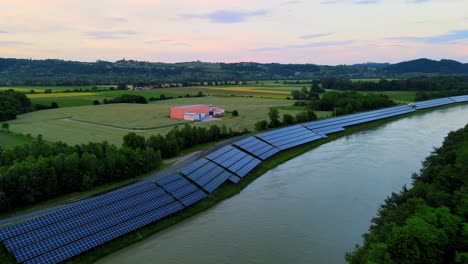 Captivating-aerial-4K-drone-footage-of-a-solar-panel-plant-nestled-alongside-the-Drava-river-in-Slovenia