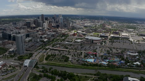 Downtown-Denver-Aerial-Drone-cinematic-South-Platte-River-Elitch-Gardens-Ball-Arena-DU-MSCD-cityscape-Colorado-cars-traffic-parking-lot-Nuggets-Avalanche-Broncos-spring-summer-circling-left-movement