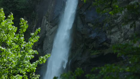 Water-Flowing-Down-Rocky-Wall,-Foroglio-Waterfall-In-Bavona-Valley,-Switzerland---tilt-down