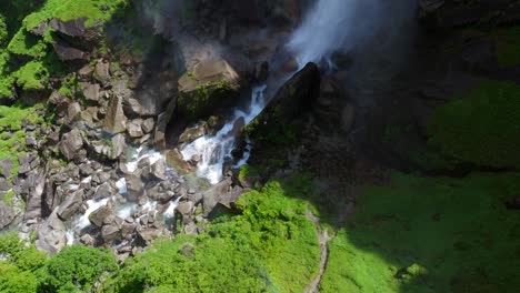Cascade-Falls-Down-On-Rock-Boulders-In-Foroglio-Waterfall,-Bavona-Valley,-Switzerland---drone-shot