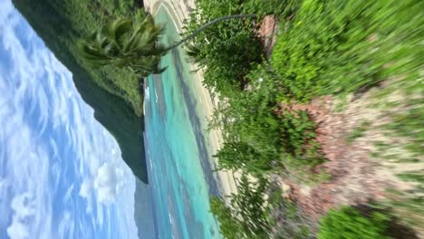 FPV-vertical-flight-over-tropical-landscape-with-beautiful-sandy-beach-and-turquoise-sea-water-during-sunny-day