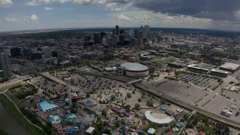 Downtown-Denver-Aerial-Drone-cinematic-South-Platte-River-Elitch-Gardens-Ball-Arena-DU-MSCD-cityscape-Colorado-cars-traffic-parking-lot-Nuggets-Avalanche-Broncos-spring-summer-circling-right-movement