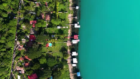 Aerial-top-down-view-of-houses-at-the-shore-of-the-Coatepeque-volcanic-lake-in-El-Salvador